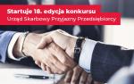 Dwie ręce w uścisku a nad nimi napis: startuje 18, edycja konkursu Urząd Skarbowy Przyjazny Przedsiębiorcy